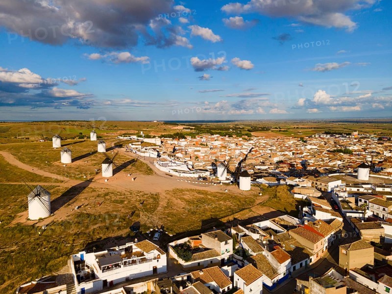 Aerial view of a village with several windmills and houses under a blue sky with clouds, aerial view, windmills, Campo de Criptana, Ciudad Real province, Castilla-La Mancha, Route of Don Quixote, Spain, Europe