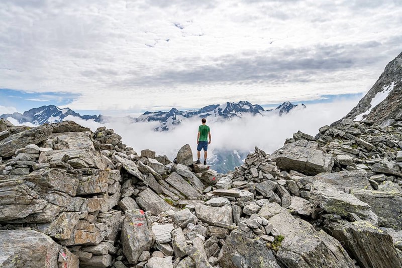 Mountaineer in a rocky saddle, Lapenscharte with view of mountain peaks, Berliner Höhenweg, Zillertal Alps, Tyrol, Austria, Europe