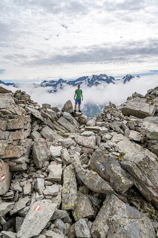 Mountaineer in a rocky saddle, Lapenscharte with view of mountain peaks, Berliner Höhenweg, Zillertal Alps, Tyrol, Austria, Europe