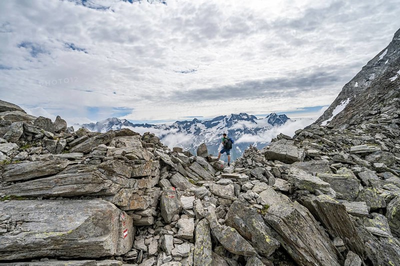 Mountaineer in a rocky saddle, Lapenscharte with view of mountain peaks, Berliner Höhenweg, Zillertal Alps, Tyrol, Austria, Europe