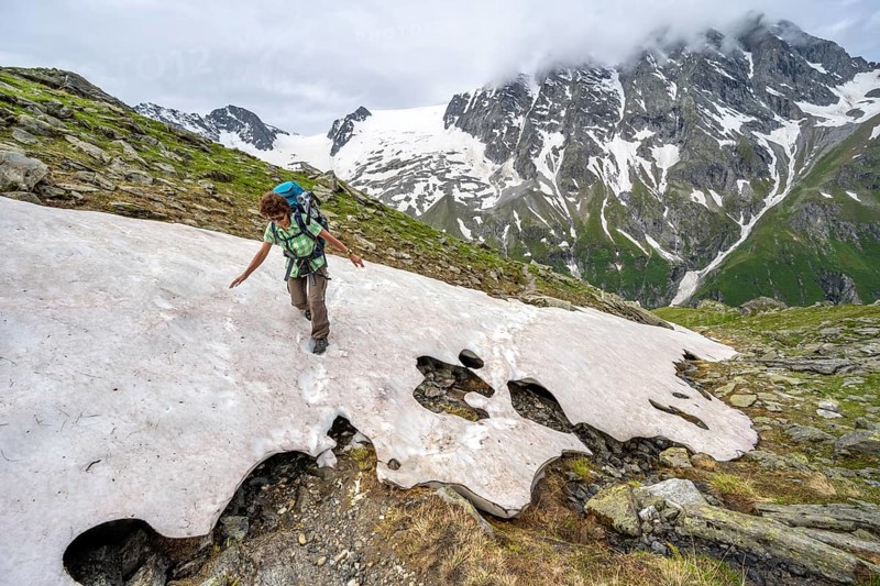 Mountaineer climbing over a snowfield to the Lapenscharte, Berliner Höhenweg, Zillertal Alps, Tyrol, Austria, Europe