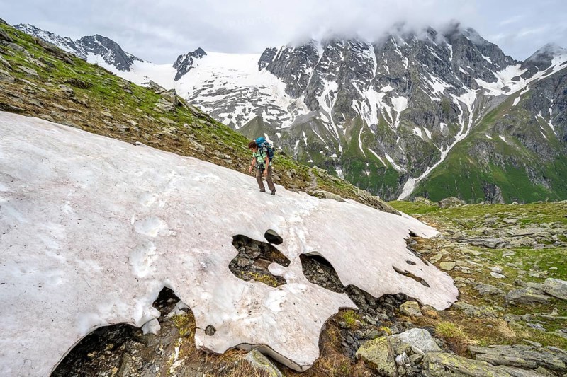 Mountaineer climbing over a snowfield to the Lapenscharte, Berliner Höhenweg, Zillertal Alps, Tyrol, Austria, Europe