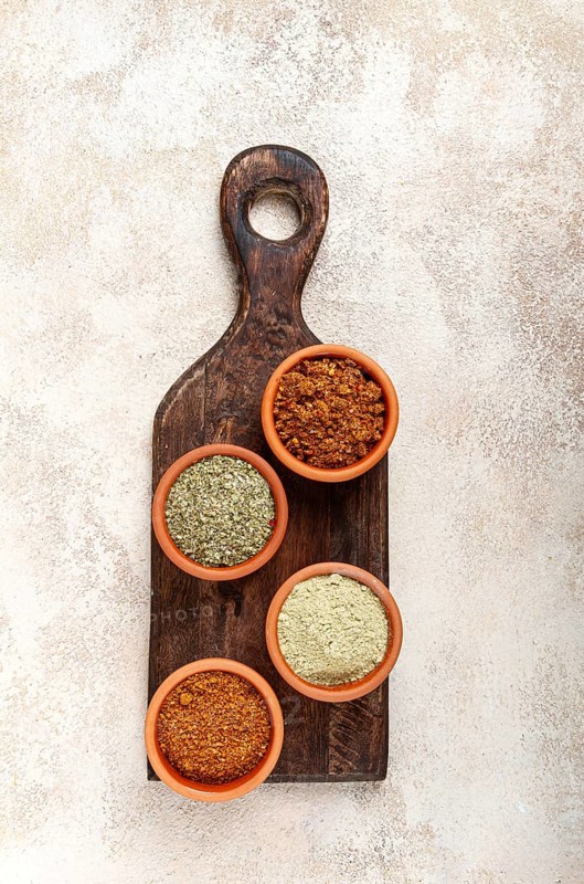 Georgian spices, in ceramic bowls, assortment, set of spices, utsho, adjika, Svan salt, ground coriander, top view, no people