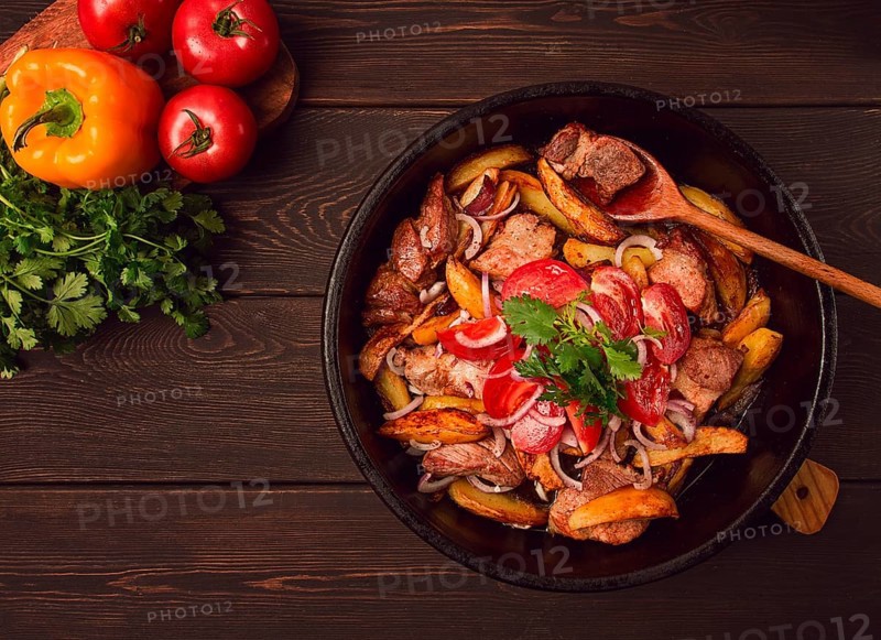 Ojakhuri, Traditional Georgian dish, fried potatoes with meat, in a clay frying pan, top view, no people, homemade