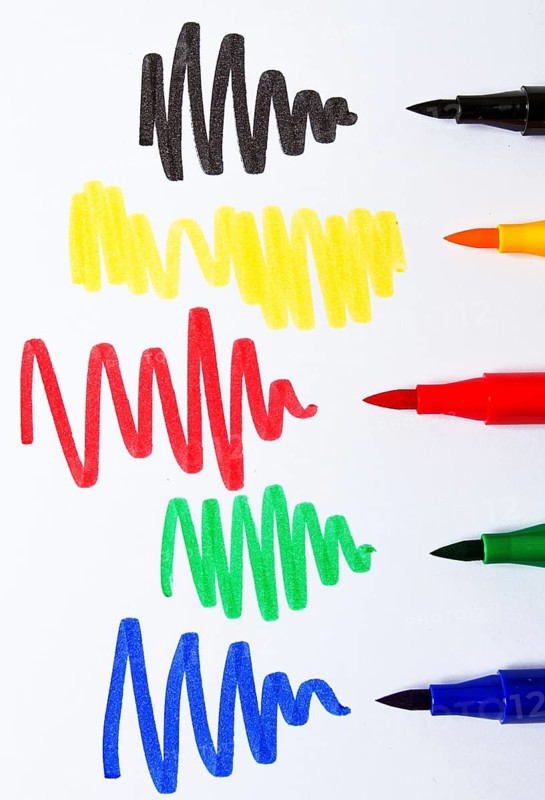 Watercolor pens brush, assortment, on a drawing album, artist's desk, top view, close-up, selective focus