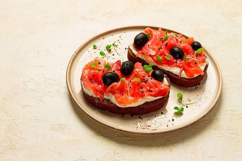 Sandwiches with red fish, cream cheese, olives and microgreens, breakfast