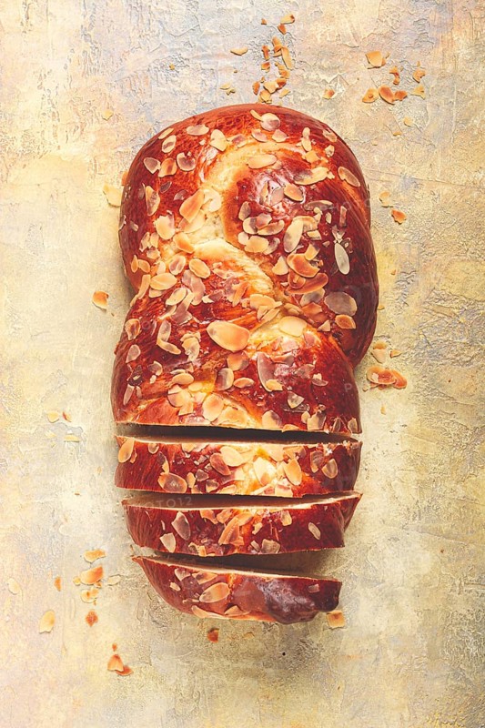 Braided, sweet bread pie, with sliced almonds, breakfast, braided bread, brioche, on a light background, top view, no people