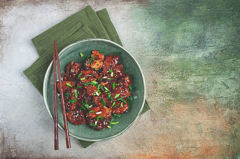 Yakitori chicken kebab, on a plate, with green onions and sesame seeds, top view, no people