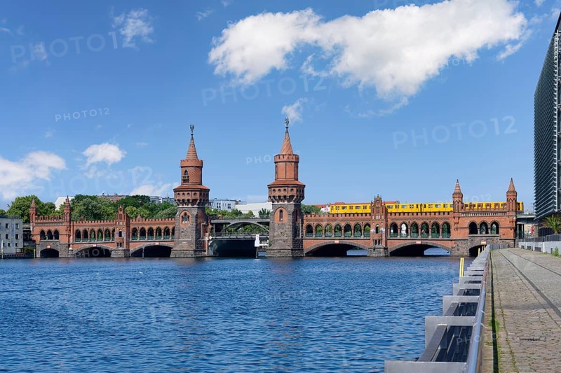 Yellow S-Bahn crossing the Double deck Oberbaum bridge over the Spree river, Berlin, Germany, Europe