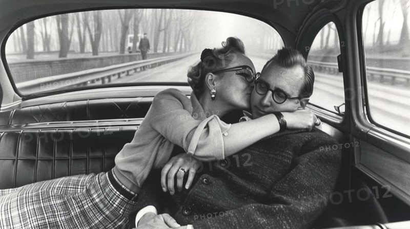 A black and white vintage photograph of a couple kissing inside a classic car, creating a nostalgic and cozy atmosphere, AI generated