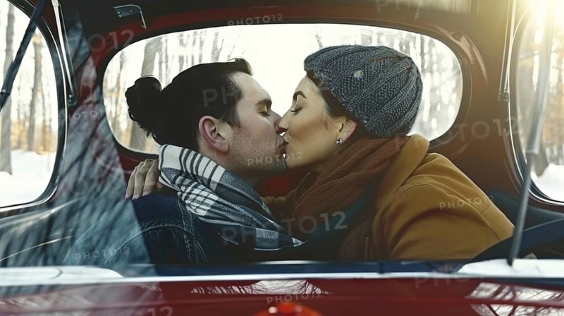 A couple sharing a kiss in a car during winter, both dressed warmly in scarves and hats, AI generated