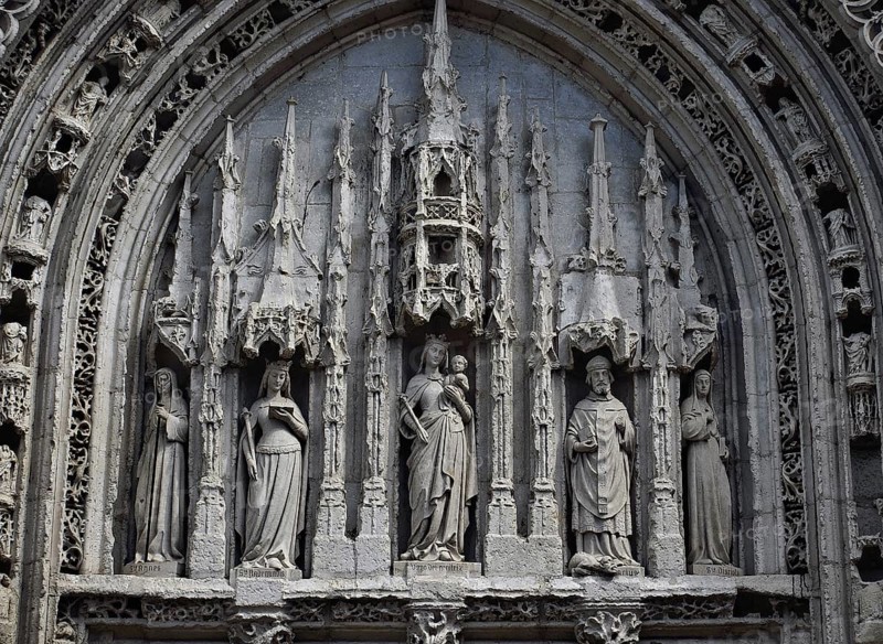 Tympanum at the Sainte Radegonde church (Poitiers, France) . Sainte Radegonde is 2th from left, Saint Hilaire 2th from right, the Virgin in the middle