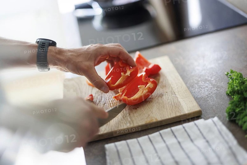 Cooking topic. A man cuts a sweet pepper. Berlin, 01.08.2024