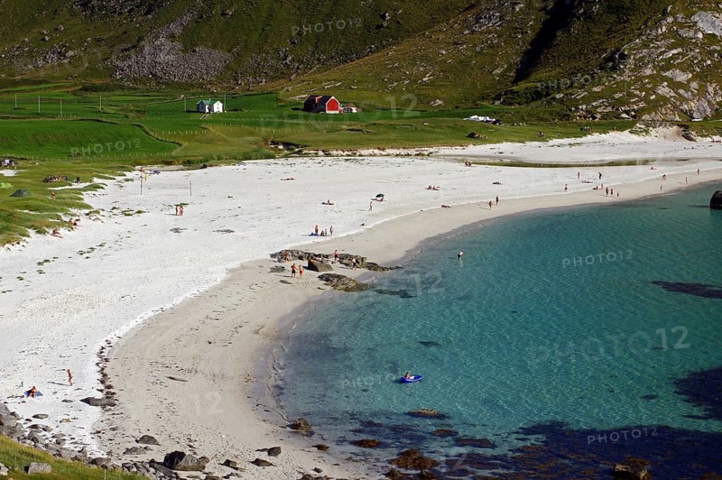 A white sandy beach with people, turquoise water and cliffs in the background, Haukland, Leknes, Lofoten, Nordland, Norway, Europe