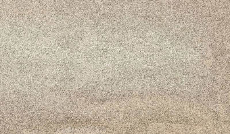 Beige plastered wall with rough texture creating a neutral background