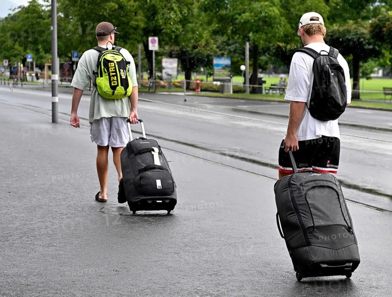 Tourists with wheeled suitcases