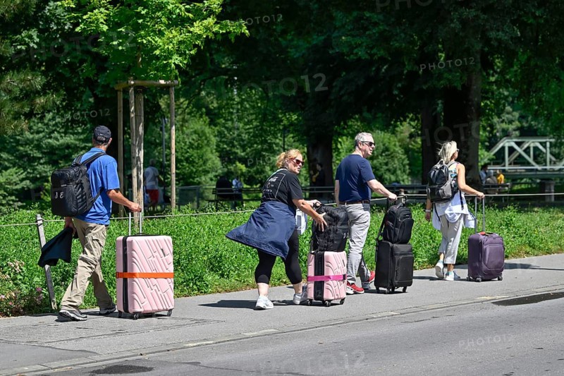 Tourists with wheeled suitcases