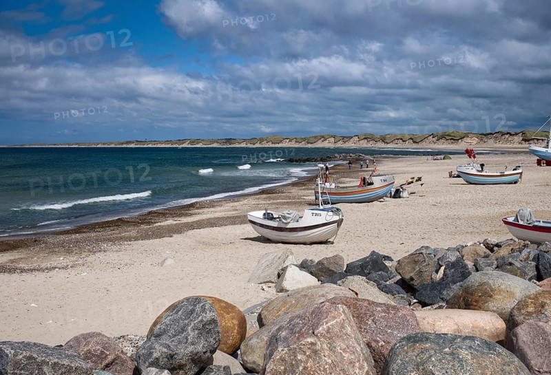 The beach at Norre Vorupor with rocks in the foreground in North Jutland, Denmark, Europe