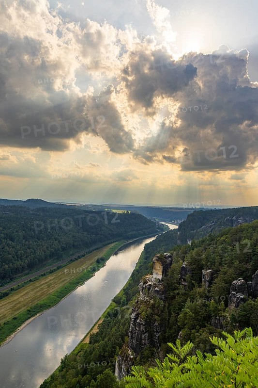 The Bastei is a rock formation with a viewing platform in Saxon Switzerland on the right bank of the River Elbe in the municipality of Lohmen between the spa town of Rathen and the town of Wehlen. It is one of the most visited tourist attractions in Saxon Switzerland. Dramatic sky over the Bastei, Saxon Switzerland, Rathen, Saxony, Germany, Europe