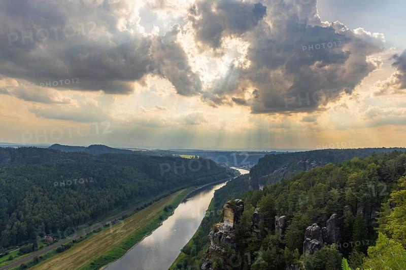 The Bastei is a rock formation with a viewing platform in Saxon Switzerland on the right bank of the River Elbe in the municipality of Lohmen between the spa town of Rathen and the town of Wehlen. It is one of the most visited tourist attractions in Saxon Switzerland. Dramatic sky over the Bastei, Saxon Switzerland, Rathen, Saxony, Germany, Europe