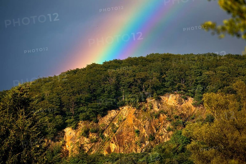 Intense rainbow in front of dark clouds over the Wartenberg, Witten, Ruhr area, North Rhine-Westphalia, Germany, Europe