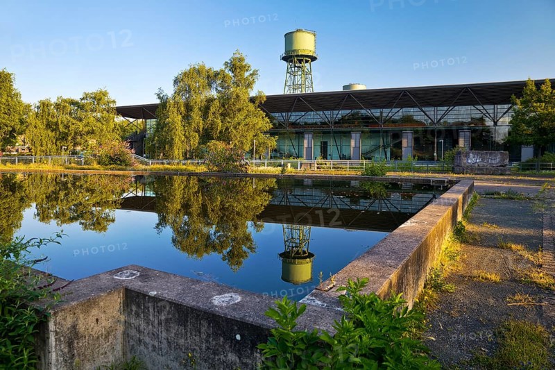 The water tower with the Jahrhunderthalle in Westpark, industrial heritage, Bochum, Ruhr area, North Rhine-Westphalia, Germany, Europe