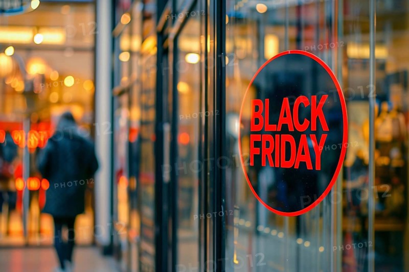 Round black advertisement sign with red text 'Black Friday' in shopping window. Generative AI, AI generated