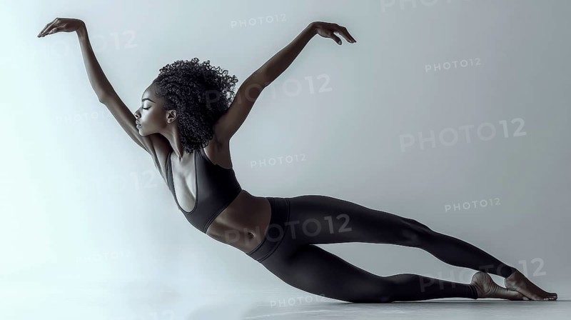 A ballerina in a black outfit gracefully extends in a side pose, showcasing elegance and balance, AI generated