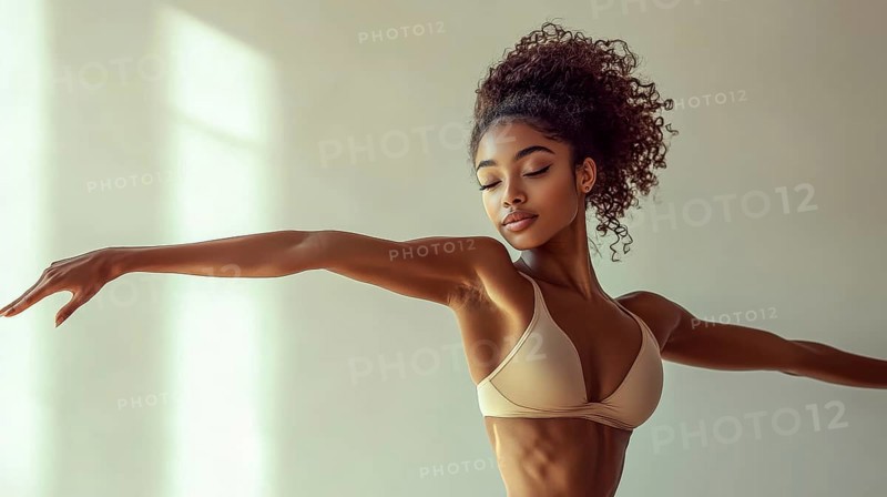 A woman gracefully posing in natural light, exuding elegance, serenity, and strength in an athletic setting, AI generated