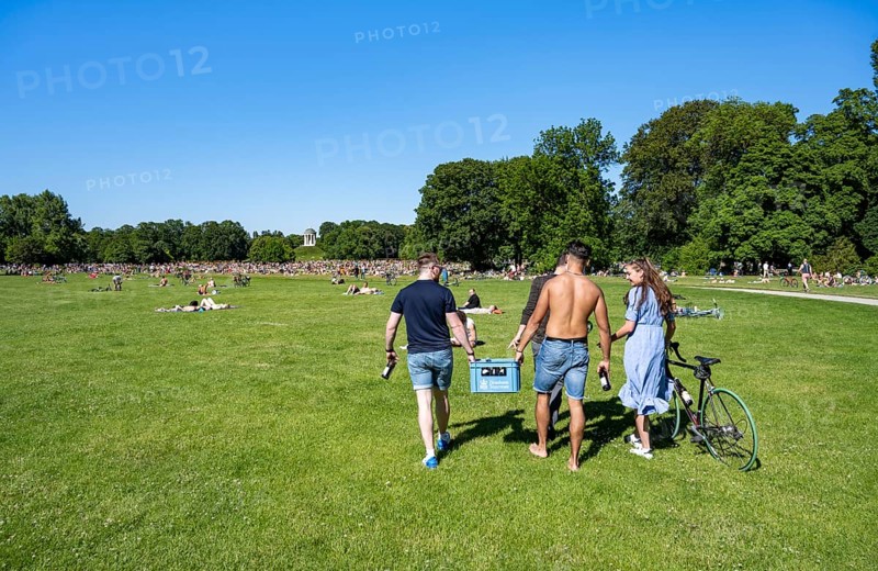 Young people with beer crates and beer in the English Garden, people enjoying the summer day in the park, Munich, Upper Bavaria, Bavaria, Germany, Europe