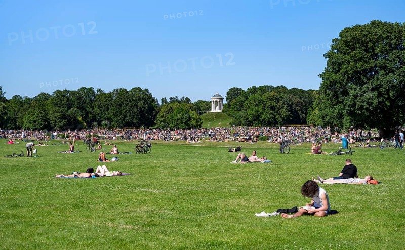 Many people in a meadow in the English Garden, people enjoying the summer day in the park behind Monopteros, Munich, Upper Bavaria, Bavaria, Germany, Europe