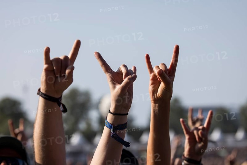 Metal fans show the French fries fork, a greeting in the metal scene, at the Wacken Open Air in Wacken. The traditional metal festival takes place from 31 July to 2 August 2024