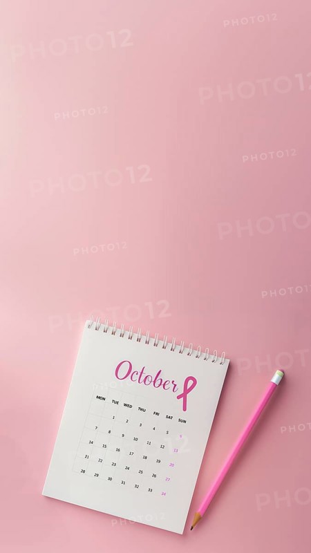 October calendar with a breast cancer awareness pink ribbon and a pencil with copyspace. Vertical shot, AI generated