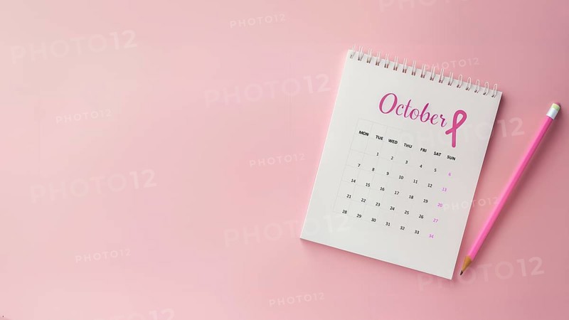 October calendar with a breast cancer awareness pink ribbon and a pencil with copyspace, AI generated