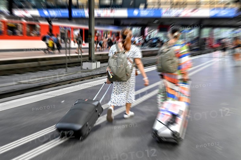 Wipe-off picture SBB railway station passers-by with trolley case