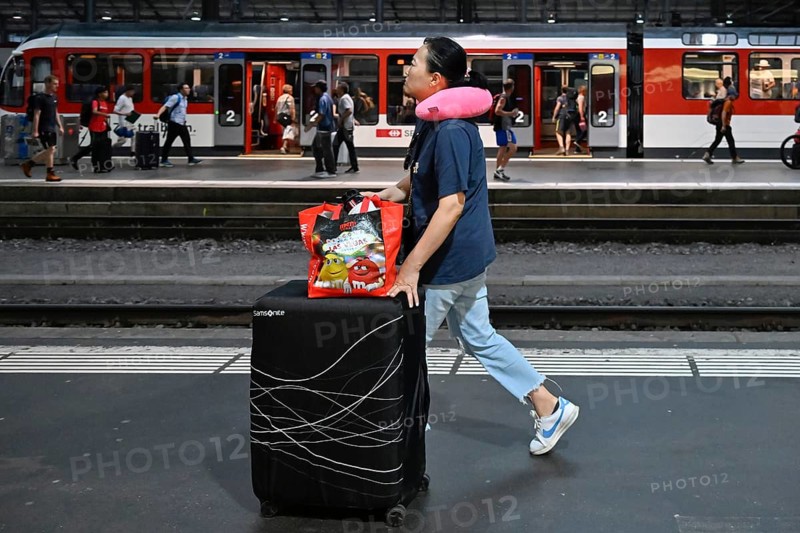 SBB railway station passer-by with trolley case