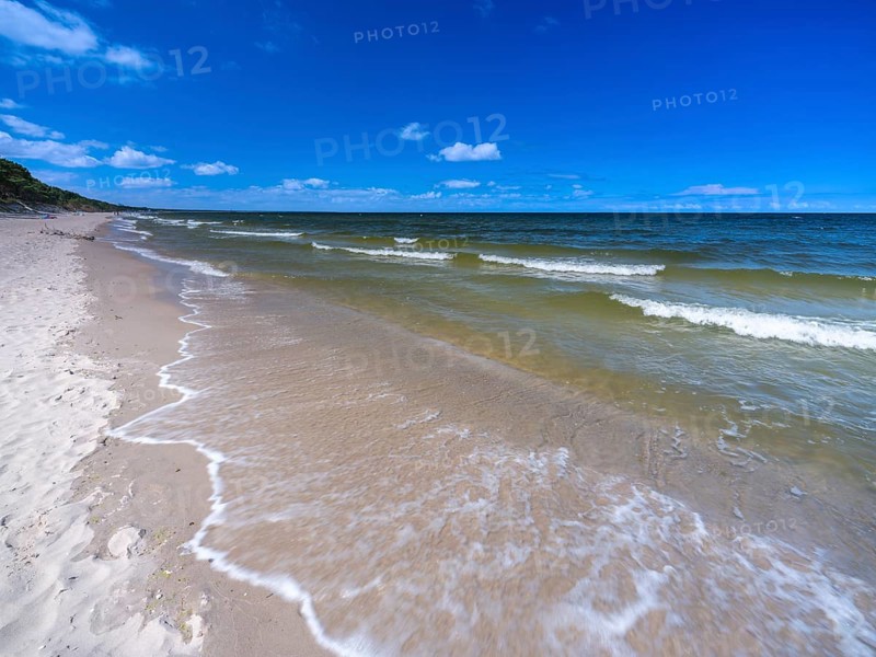 Water flowing onto the sandy beach on the island of Usedom on the Baltic Sea under a blue sky with clouds, Zempin, Mecklenburg-Vorpommern, Germany, Europe