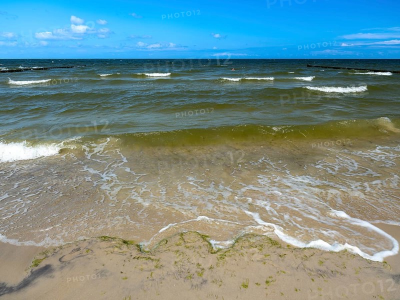 Water flowing onto the sandy beach on the island of Usedom on the Baltic Sea under a blue sky with clouds, Zempin, Mecklenburg-Vorpommern, Germany, Europe