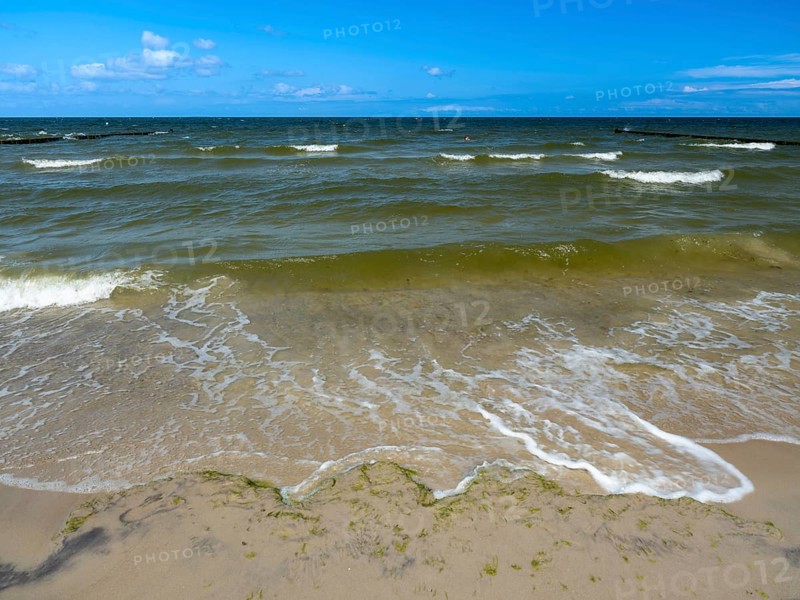 Water flowing onto the sandy beach on the island of Usedom on the Baltic Sea under a blue sky with clouds, Zempin, Mecklenburg-Vorpommern, Germany, Europe