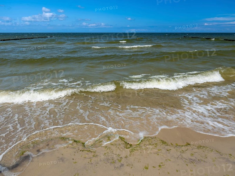 Water flowing onto the sandy beach on the island of Usedom on the Baltic Sea under a blue sky with clouds, Zempin, Mecklenburg-Vorpommern, Germany, Europe