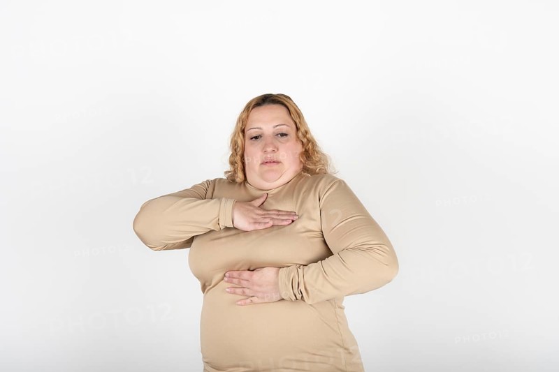Plus size woman doing a Breast Self-Exam (BSE)