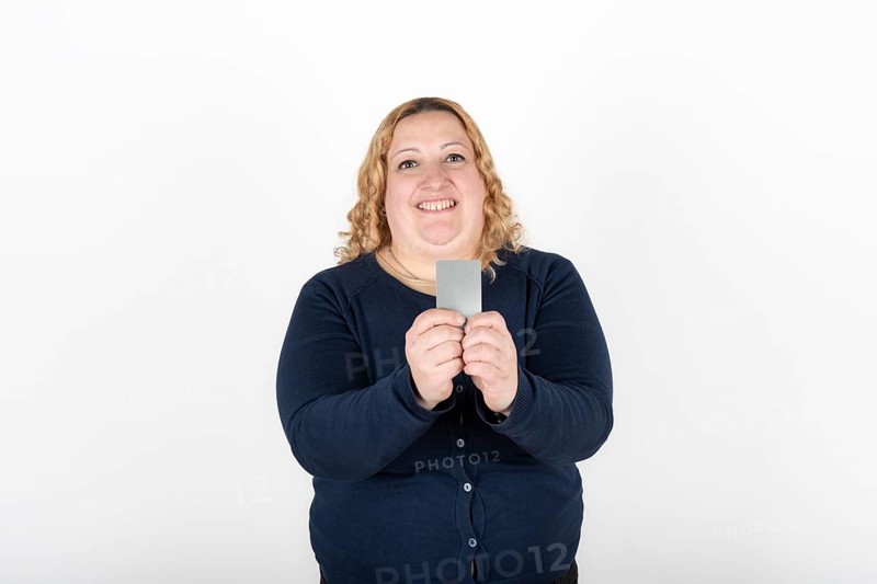 Woman smiling happily showing her credit card
