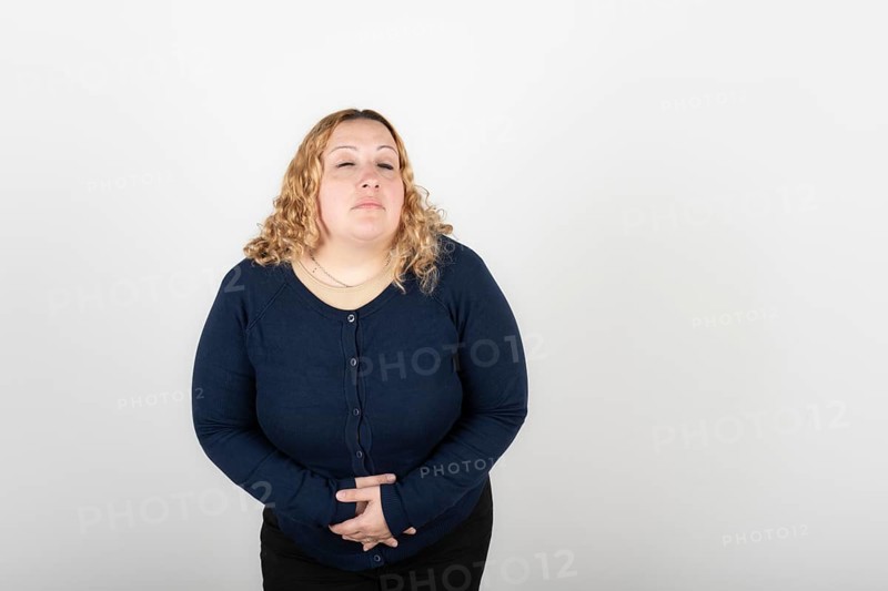Woman with stomach ache on white background