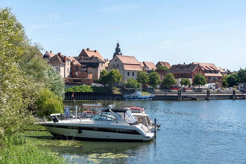 A boat is anchored, behind it parts of the old town centre of Havelberg, Saxony-Anhalt, Germany, Europe