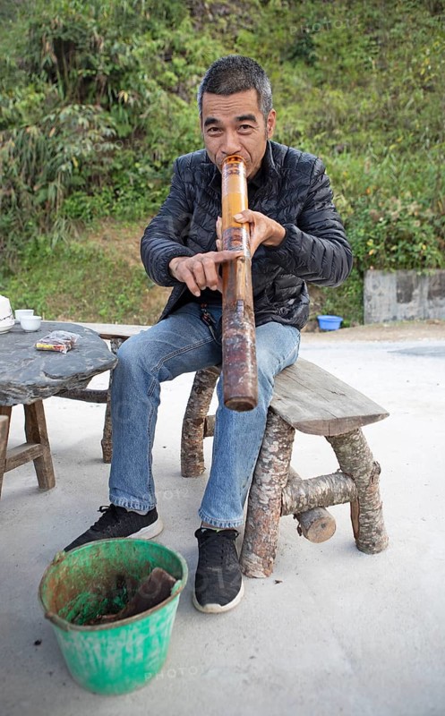 Vietnamese man smoking a thick bamboo pipe, Ha Giang province, Vietnam, Asia