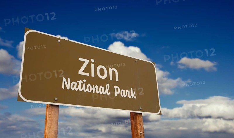 Zion national park (utah) road sign against blue sky and clouds