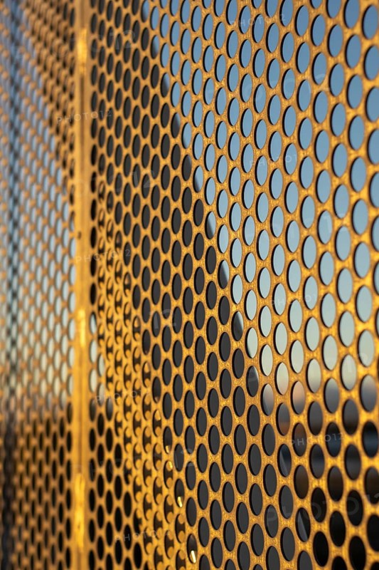 Aluminum composite panels or cladding with perforated sheets on modern building facade on sunset, Abstract architecture background concept, AI generated