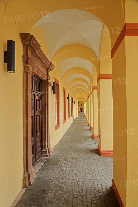 Yellow arcade from inside with archways and pillars, University, Lower Castle built 17th century, baroque, long corridor, yellow, vanishing point, row, series, geometric, Siegen, Siegerland, North Rhine-Westphalia, Germany, Europe