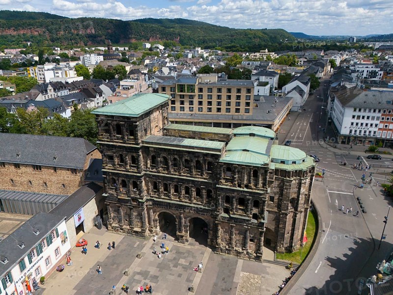 Historical architecture of the Porta Nigra with city view and green roofs in Germany, aerial view, Porta Nigra, Black Gate, Roman city gate, Trier, Rhineland-Palatinate, Germany, Europe