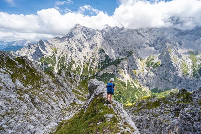 Mountaineer climbing Waxenstein, Alpspitze Wetterstein range in the background, Garmisch-Patenkirchen, Bavaria, Germany, Europe